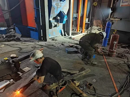 Chamber-body work documented on hook-type shot blasting equipment